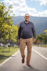 Mature smiling man walking