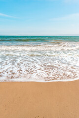 Background sea beach with waves and foam. Sandy beach and sea turquoise waves. Feeling of carelessness, enjoyment of freedom and happiness.