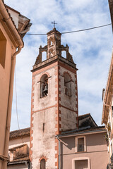 a tower with a clock on it .La vall de gallinera, Alicante, Spain