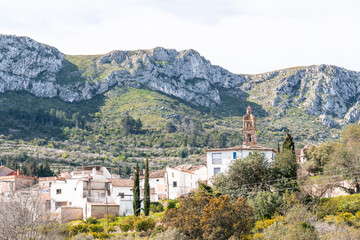 a view of a village in the mountains with trees and mountains .La vall de gallinera, Alicante, Spain