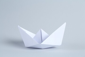 Beautiful paper boat on light grey background