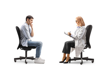 Pensive man sitting in a chair opposite a female doctor