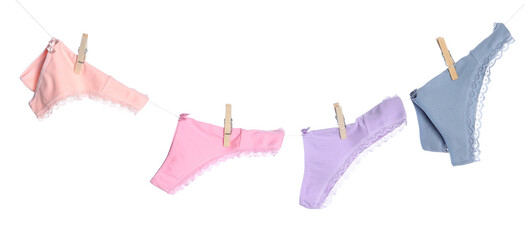 Women's underwear. Beautiful panties on clothes line against white background