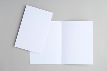 Blank greeting cards on light background, top view