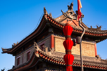 Old wall in Xian, China with traditional towers and red lanterns