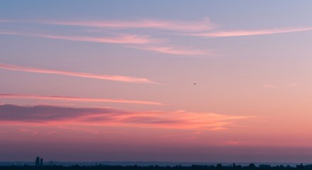 Fototapeta premium Sky at Dusk with Clouds and Distant City Silhouette