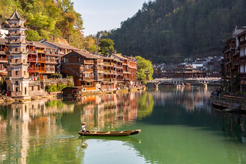 Fenghuang ancient town, China. Traditional chinese wooden houses and a boat