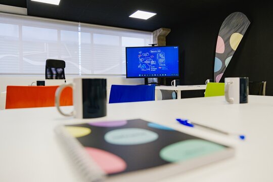 Modern training room with colorful chairs and presentation screen