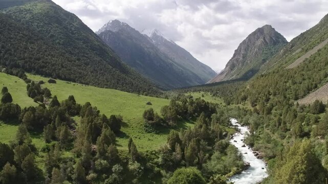 4K aerial footage captures the breathtaking mountain scenery and lush green terrain of Ala Archa National Park in Kyrgyzstan.