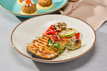Vibrant Salmon Steak with Grilled Vegetables on Elegant Plate in Natural Light