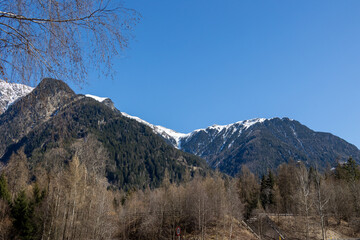 Mountain landscape in early spring with forested slopes and snow-covered peaks, &Ouml;tztal, Austria..