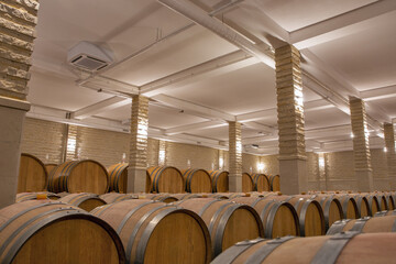 Wine barrels in the cellar of wine producer.