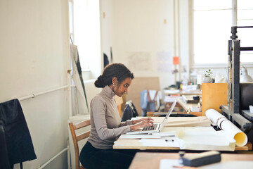 student at an art school uses a computer