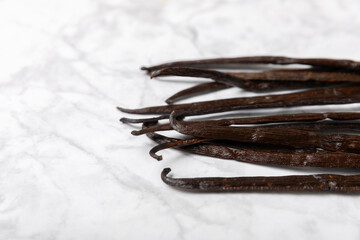 Vanilla pods on a textured background. Vanilla flowers and seeds. vanilla stick bean. Aromatic...