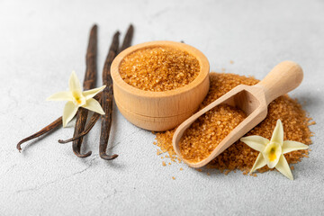 Aromatic vanilla sugar. Vanilla pods. Vanilla sticks, brown and white sugar in a bowl on a textured background. Vanilla flowers, spices and herbs for desserts and baking. Space for text. Copy space