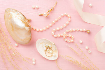 Elegant golden jewelry with decoration on wooden background, top view