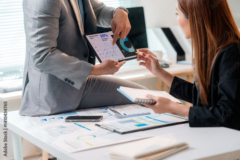 Poster business people analyzing financial charts and graphs using digital tablet during a meeting