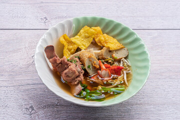 Tom Yum noodles, spicy soup with pork, fish balls, morning glory, bean sprouts