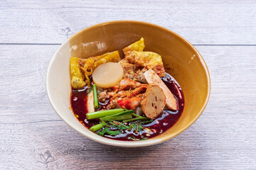 Tom Yum noodles, spicy soup with pork, fish balls, morning glory, bean sprouts