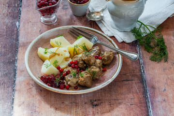Traditional Swedish meatballs in creamy sauce with boiled potatoes and lingonberries