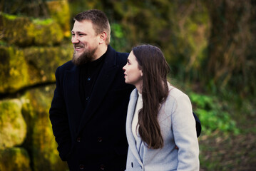 Young caucasian couple smiling outdoors in nature setting
