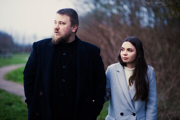 Caucasian adult couple walking in nature during winter