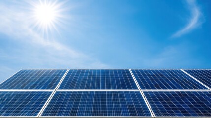 Obraz premium Bright Sun Over Solar Panel Array with Clear Blue Sky and Vibrant Sunlight