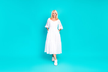 Stylish Blonde Woman in White Summer Dress on a Bright Turquoise Background, Radiating Confidence, Charm, and Seasonal Elegance