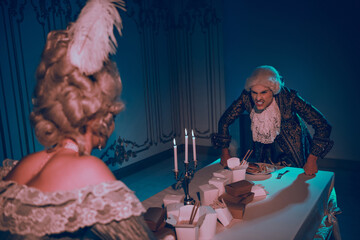 Elegant couple in vintage attire engaged in a theatrical scene of humor and drama