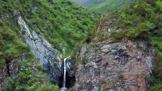 Overhead drone footage of the dramatic Darial Gorge, where the Terek River carves through sheer granite cliffs towering up to 1,800 meters along the border of Georgia and Russia.