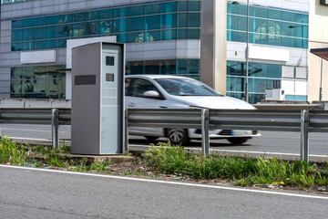 Fixed speed camera radar controlling traffic and detecting speeding vehicles on a highway in Spain.