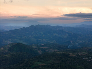Fototapeta premium Sunset over mountains and distant hills in serene, scenic view