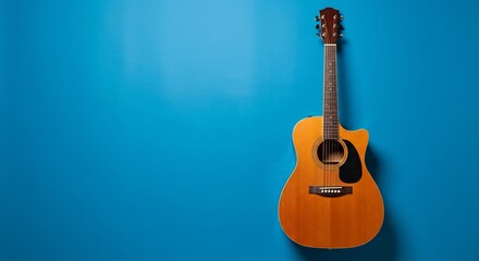 Naklejka premium 青背景に輝く木製のギター、シンプルで美しい構図