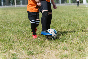 Close-up of two boys competing for soccer ball.