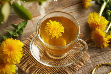 A glass cup of dandelion tea on a table