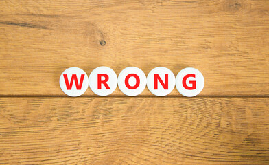 Wrong symbol. Concept word Wrong on beautiful white pills circles. Beautiful wooden table wooden...