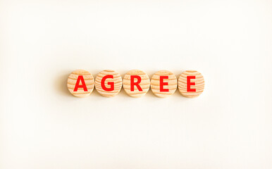 Agree symbol. Concept word Agree on beautiful wooden circles. Beautiful white table white background. Business agree concept. Copy space.