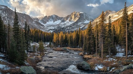 Fototapeta premium Majestic snow capped mountains overlook a vibrant river landscape with trees