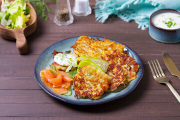 Hash browns with smoked salmon, cucumbers and yogurt. Vegetable fritters, latkes, potato cakes....