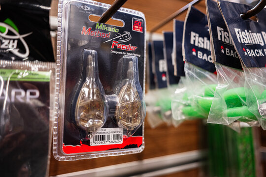 Fishing tackle store shelf with various feeders and fishing accessories on display