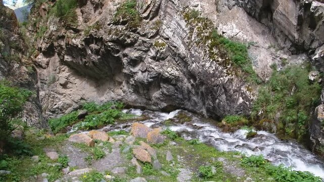 Footage of Zapata Falls plunging through narrow rock walls in southern Colorado, offering an adventurous and cool natural escape within rugged terrain.