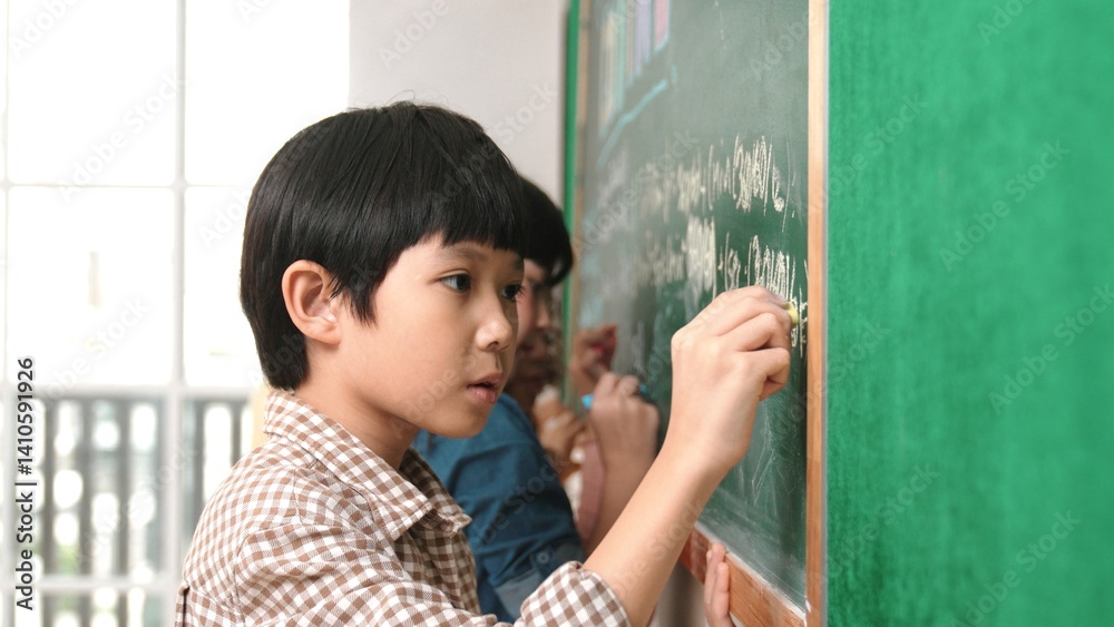 Poster side view of asian boy writing engineering prompt and programing system while standing blackboard wi