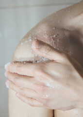 Fototapeta premium a man uses a body scrub while taking a shower