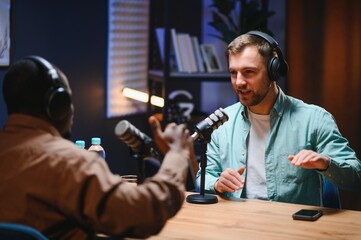 Podcast presenter having live discussion with man, streaming it for audience on internet...