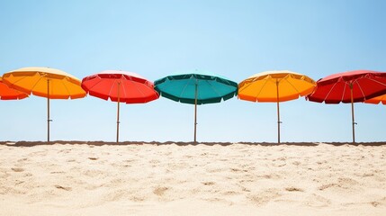 Colorful beach umbrellas line the sandy shore under a clear sky.