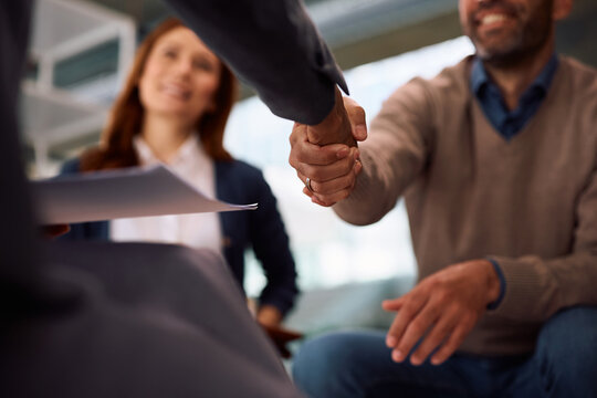 Close up of man shaking hands with bank manager after successful meeting in the office.