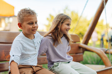 Brother and sister sharing a special moment on a park bench