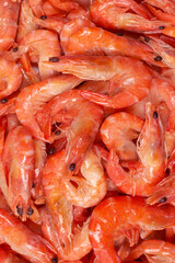 Shrimps background texture. A lot of shrimps. Cooked shrimps.