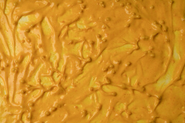 Obraz premium Yellow sauce splashes as a background.