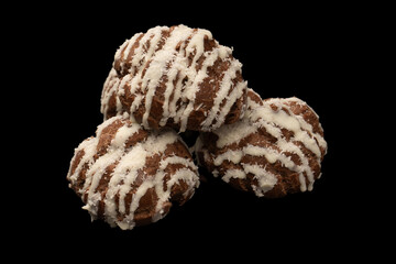 Profiteroles with coconut cream on a black background.